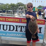 Teenage boy with a flounder on an Ocean City fishing boat dock