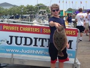 Teenage boy with a flounder on an Ocean City fishing boat dock
