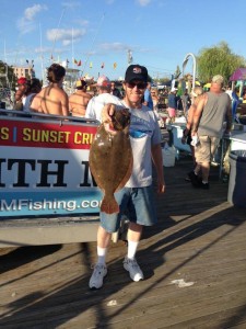 Man holding a brown flounder caught on an Ocean City charter boat