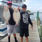 Two teenage boys holding flounder in Ocean City MD